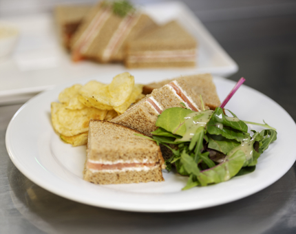 A plate with the signature sandwich on it, cold oak smoked salmon, lemon & cracked black pepper cream cheese.