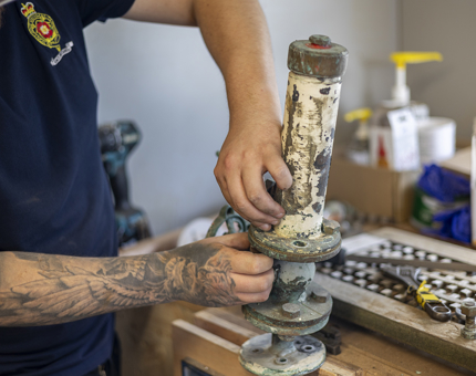 A close up of hands stripping down a part from the Royal Barge. 