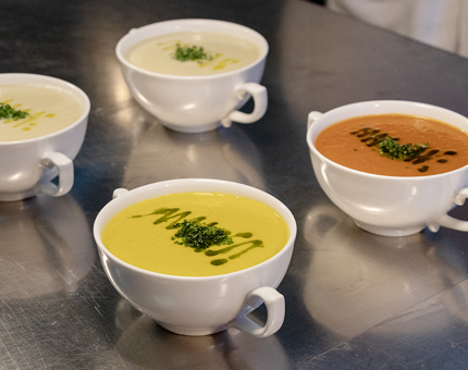 Four bowls of soup are ready to be served in The Royal Yacht Britannia's Galley.