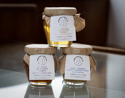 Three jars of differently flavoured honey. Scottish Blossom Honey, Scottish Heather Honey and Hot Toddy Whisky Infused Honey.