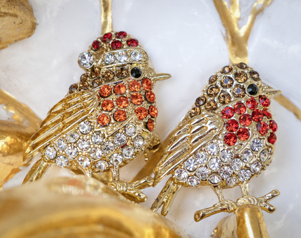 Two crystal robin brooches.
