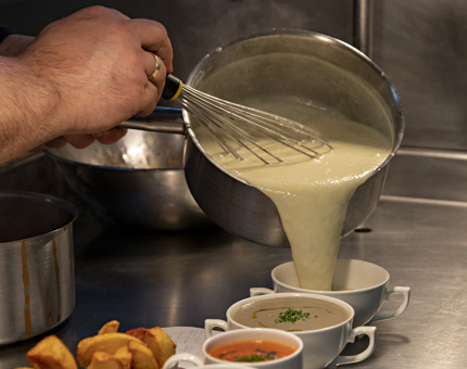Soup is being poured in the Galley. 