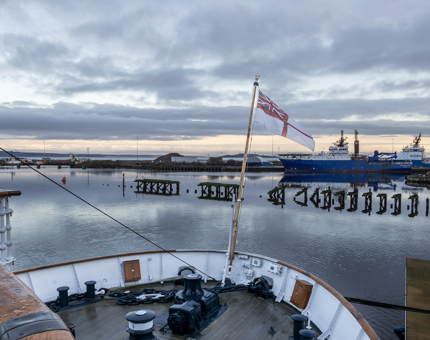 A sunrise at the stern of the Royal Yacht.