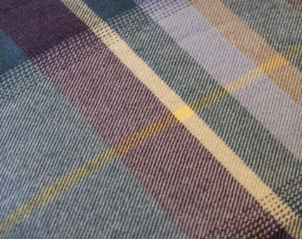 Blue, purple and yellow tartan blanket.
