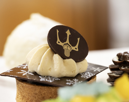 A miniature dessert with a Fingal logo chocolate disc on top.