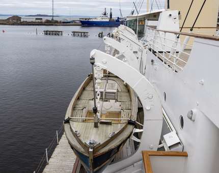 A whaler boat on the side of Britannia. 