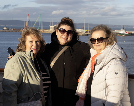 Women in coats in the sunshine