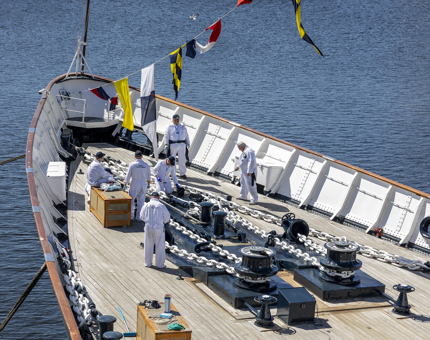 A view of the fo'c's'le from above. You can see several Yotties working there, along with the dress flags. 