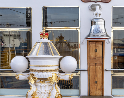 The ornamental decorative compass binnacle and silver bell on the Verandah Deck. 