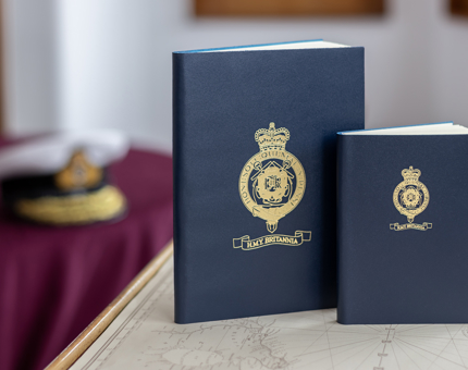 Two navy Britannia crested notebooks.