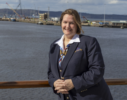 A woman standing smiling outside on Britannia.