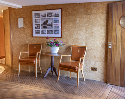 Chairs, a table and vase of flowers in Reception at Fingal. 