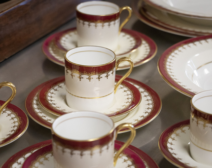 Maroon and cream decorative china cups and saucers.