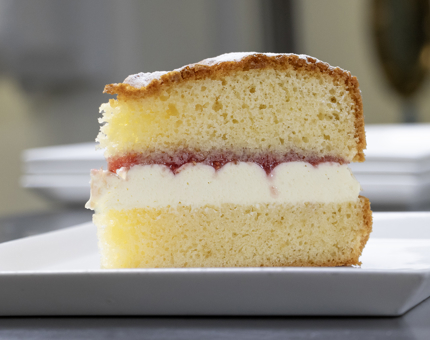 A large slice of Victoria sandwich cake.