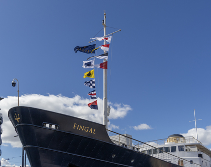 The exterior of Fingal with flags flying in the breeze. 