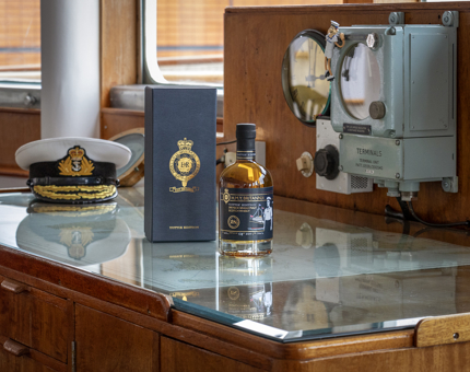 A bottle of whisky sitting next to its accompanying box in the Chart Room.