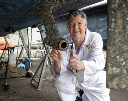 A Yottie is working on the shaft line on the Fast Motor Launch boat. 