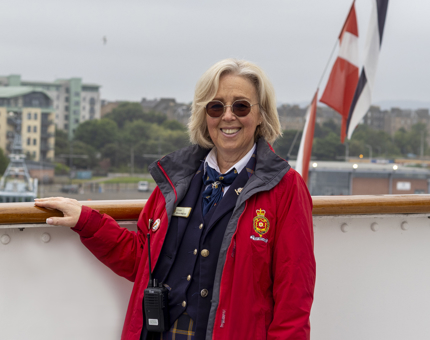 A Visitor Assistant posing for a photo outside. 