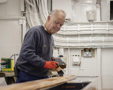 Varnishing the handrails.