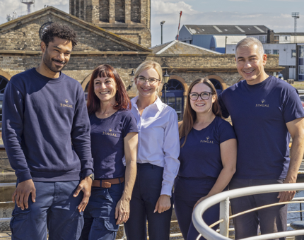 A team photo of five Housekeepers wearing their new staff uniform.