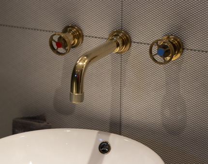 A close up of tap details in a bathroom.