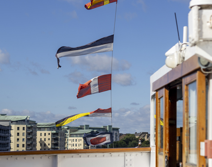 Colourful flags flying on Britannia. 