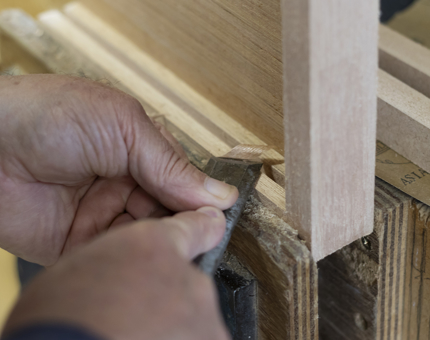 A close-up of a hand making a menu stand. 