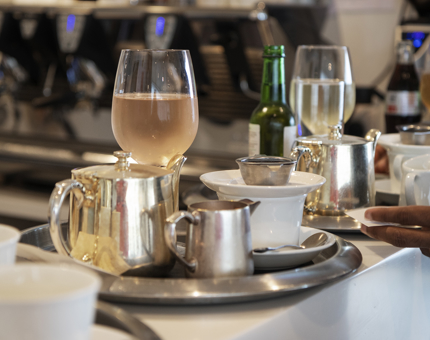 Trays of drinks on the bar waiting to be served. 