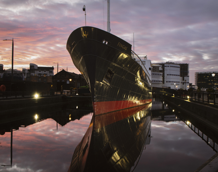 The exterior of Fingal against a pink sunset. 