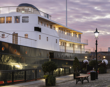The side view of Fingal with a pink sunset in the background. 