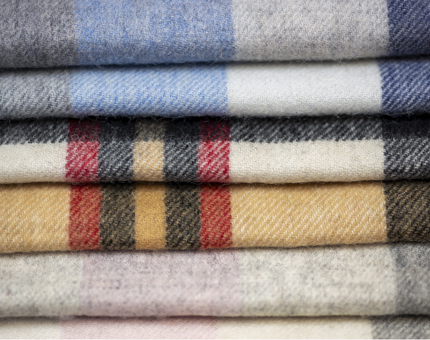 A pile of tartan scarves. 