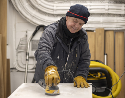 A man sanding a no entry barrier