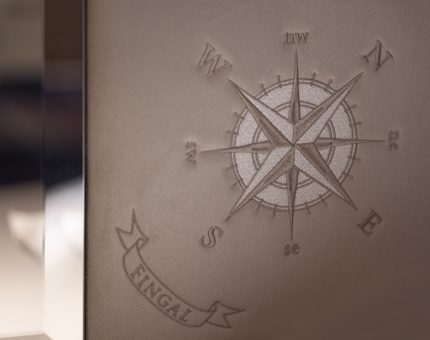 A close up of a headboard from Fingal Hotel with a compass detail. 