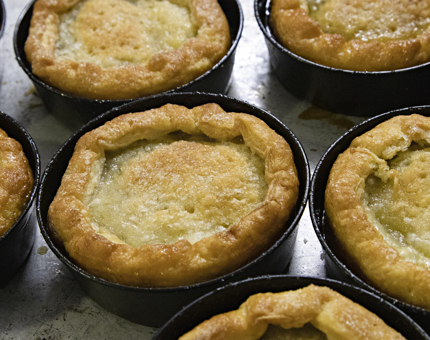A tray containing apple tarte tatin desserts.