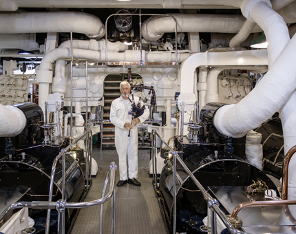 A former Royal Yachtsman in the Engine Room playing bagpipes.