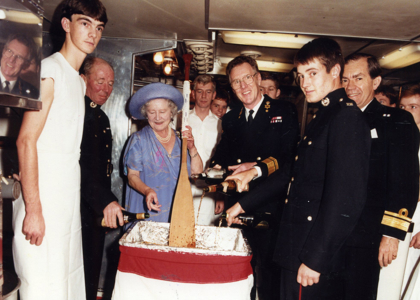 Queen Mother stirring the Christmas pudding. Royal Collection Trust / © His Majesty King Charles III 2023.