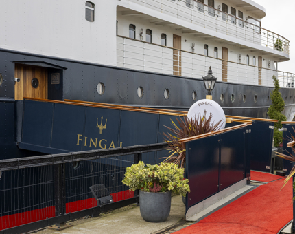 The entrance to Fingal Hotel. There is a walkway with a red carpet on it. 