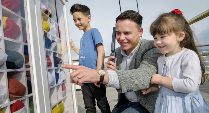 Family listen to audio guides on Britannia