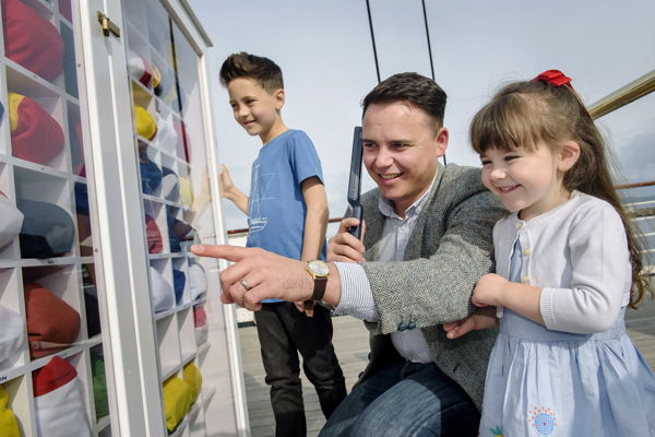 Family listen to audio guides on Britannia