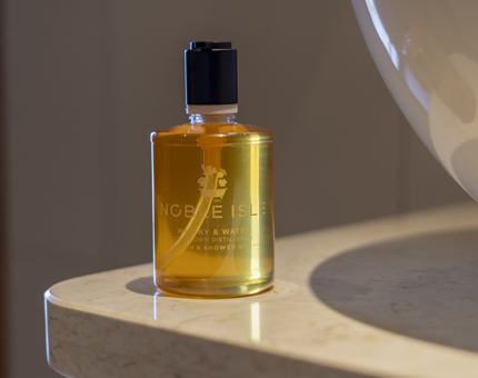 A bottle of Noble Isle whisky and water bath and shower gel. 