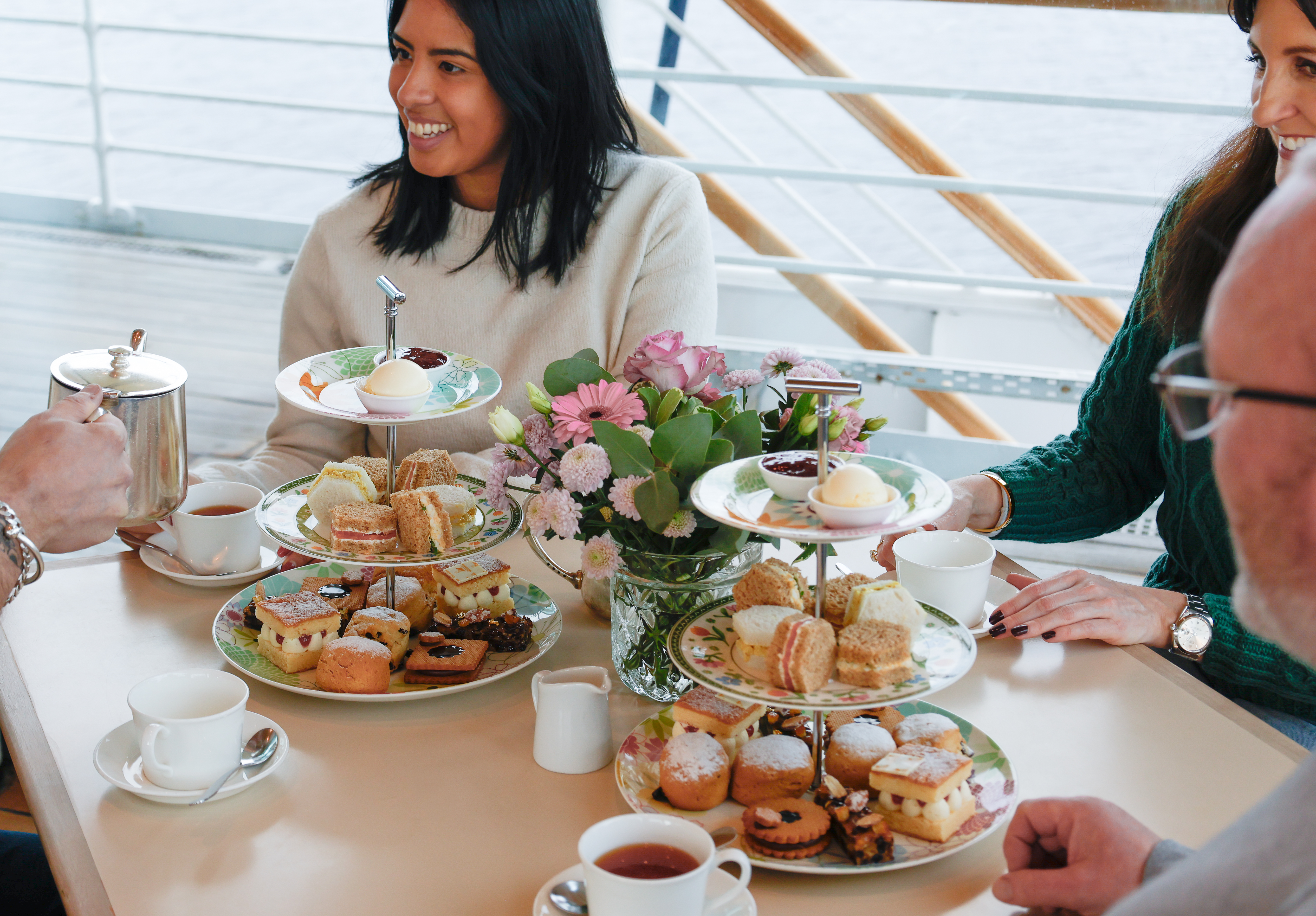 Guests enjoy an afternoon tea in the Royal Deck Tearoom on Britannia in Edinburgh.