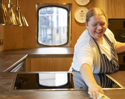 A Kitchen Porter cleaning a Galley on Fingal in Leith. 