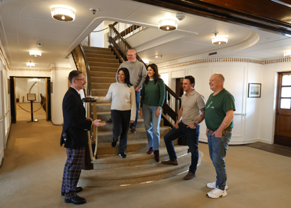 Guests Are Listening To A Tour Guide Aboard The Royal Yacht Britannia in Leith.