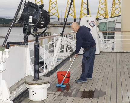 Mark, Facilities Officer, scrubbing the Decks On The Bridge in Leith. 