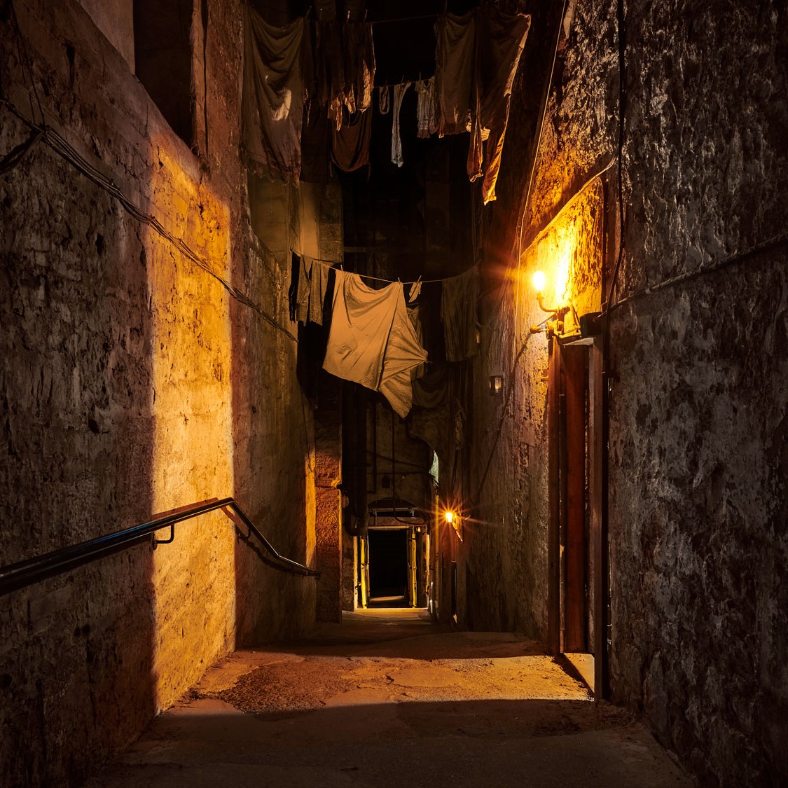 The Real Mary King's Close in Edinburgh, it is a preserved underground town with streets and rooms. There is washing lines with clothes hanging off them.