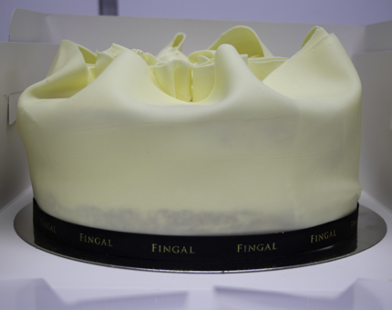 White chocolate decorated cake with Fingal ribbon.