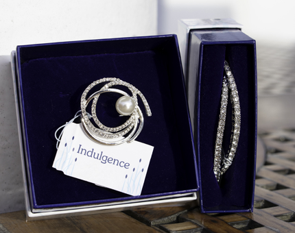 Gift boxed sparkling brooch and bracelet.