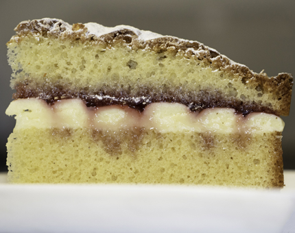 A large slice of Victoria sponge cake.
