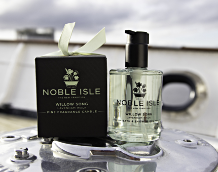 A bottle of Noble Isle bath and shower gel and a gift-boxed candle.