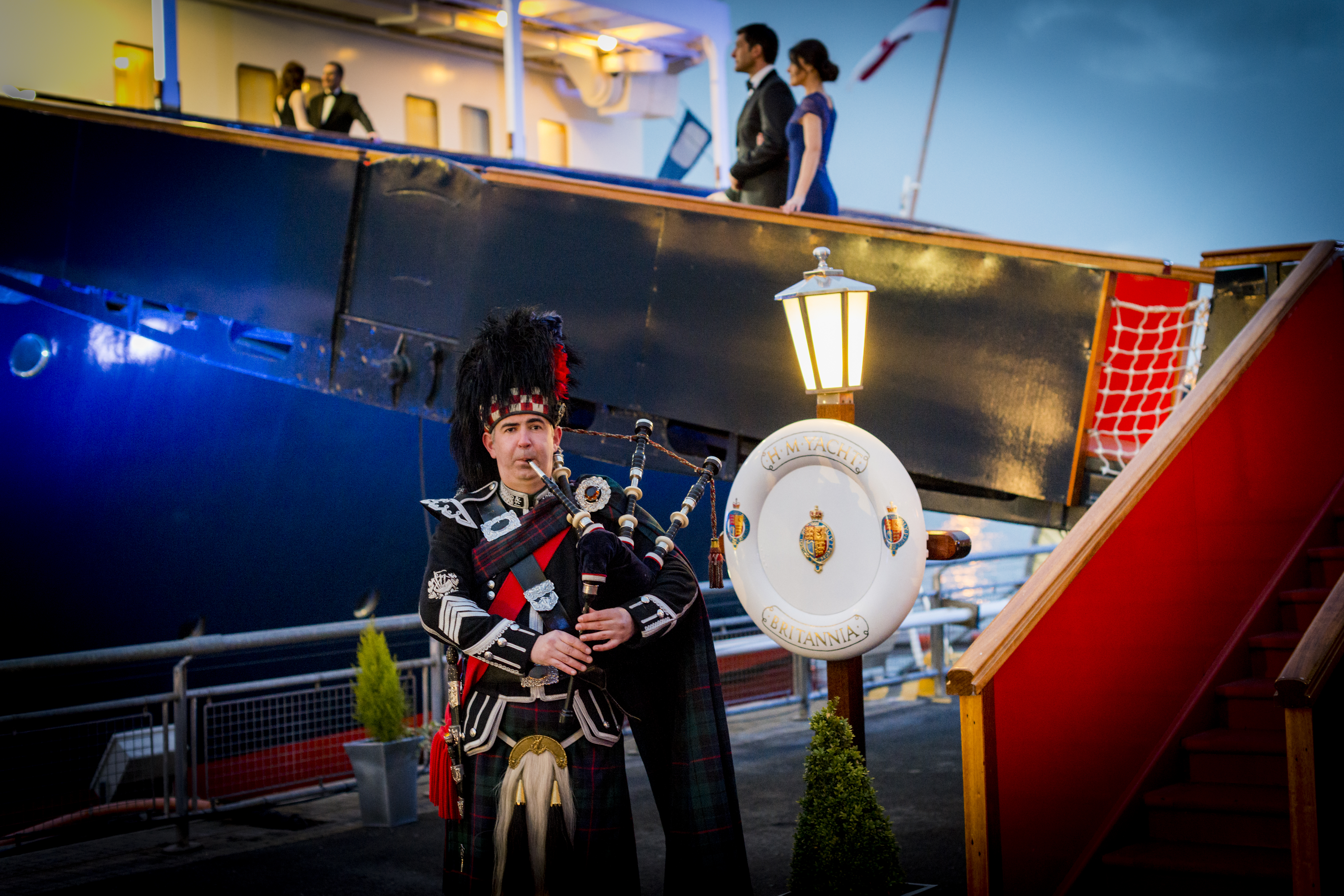 Piper playing outside The Royal Yacht Britannia